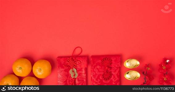 "Chinese new year festival concept, flat lay top view, Happy Chinese new year with Red envelope and gold ingot (Character "FU" means fortune, blessing) on red background with copy space for text"