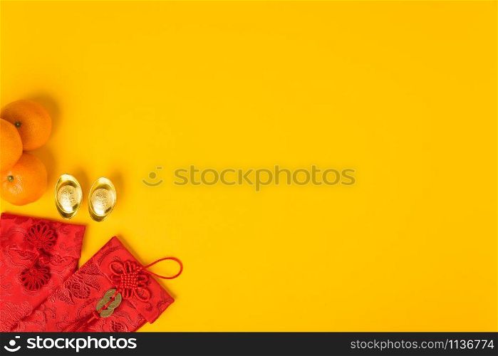 "Chinese new year festival concept, flat lay top view, Happy Chinese new year with Red envelope and gold ingot (Character "FU" means fortune, blessing) on yellow background with copy space for text"