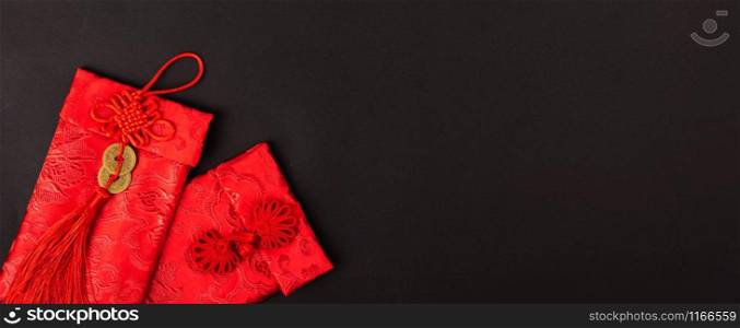 "Chinese new year festival concept, flat lay top view, Happy Chinese new year with Red envelope (Character "FU" means fortune, blessing, wealth) on black background with copy space for your text"