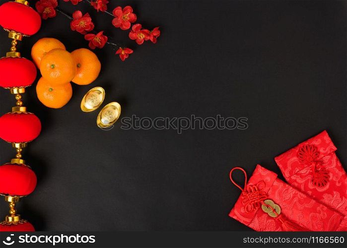 "Chinese new year festival concept, flat lay top view, Happy Chinese new year with Red envelope and gold ingot (Character "FU" means fortune, blessing) on black background with copy space for text"