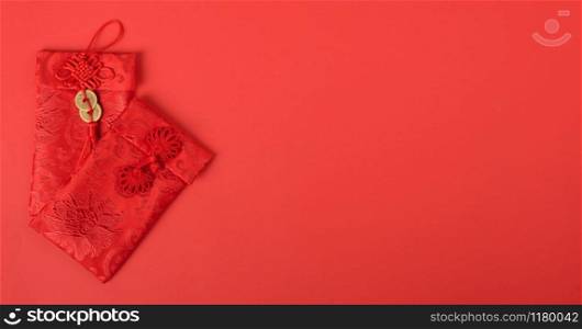 "Chinese new year festival concept, flat lay top view, Happy Chinese new year with Red envelope (Character "FU" means fortune, blessing, wealth) on red background with copy space for your text"