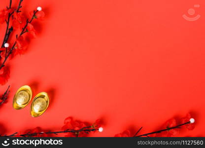 Chinese New Year, flat lay top view, gold bar and Chinese Flower on red background with copy space for your text