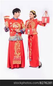 Chinese new year men and women wear cheongsam smile to get - get gift money and red bag in traditional day