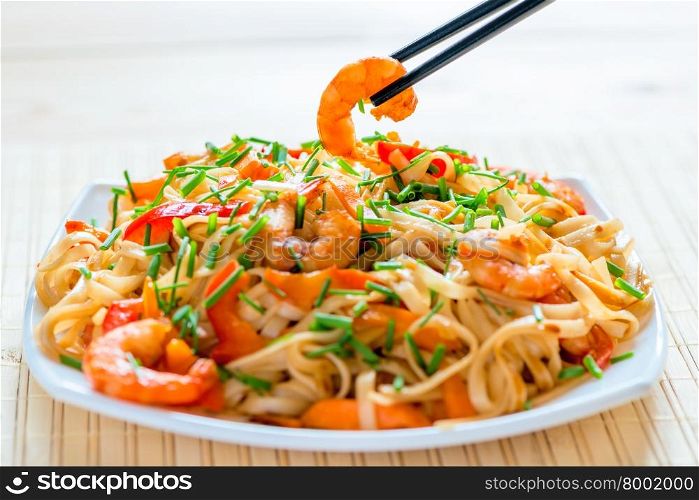 Chinese noodles with shrimp in soy sauce and vegetables