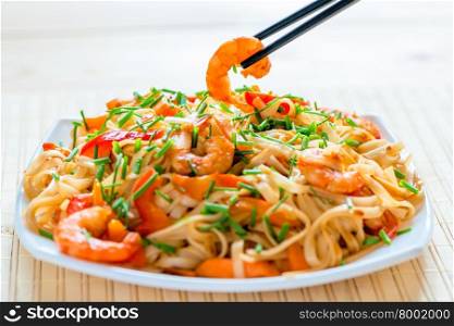 Chinese noodles with shrimp in soy sauce and vegetables