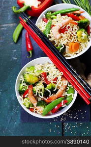 Chinese noodles with vegetables and shrimps. Food background