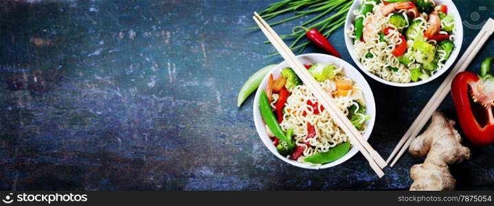 Chinese noodles with vegetables and shrimps. Food background
