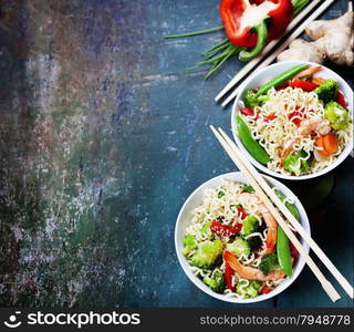 Chinese noodles with vegetables and shrimps. Food background