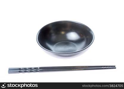 Chinese or Japanese chopsticks on empty black bowl