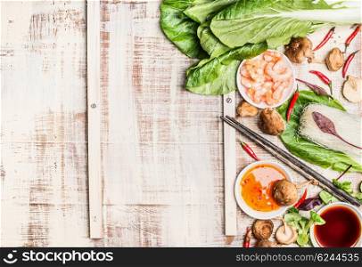 Chinese or Thai food background with Asian cooking ingredients, light rustic background, top view.