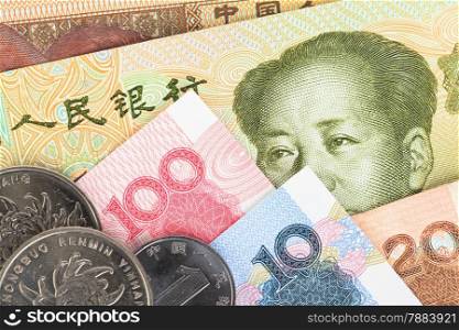 Chinese or Yuan banknotes money and coins from China&rsquo;s currency, close up view as background