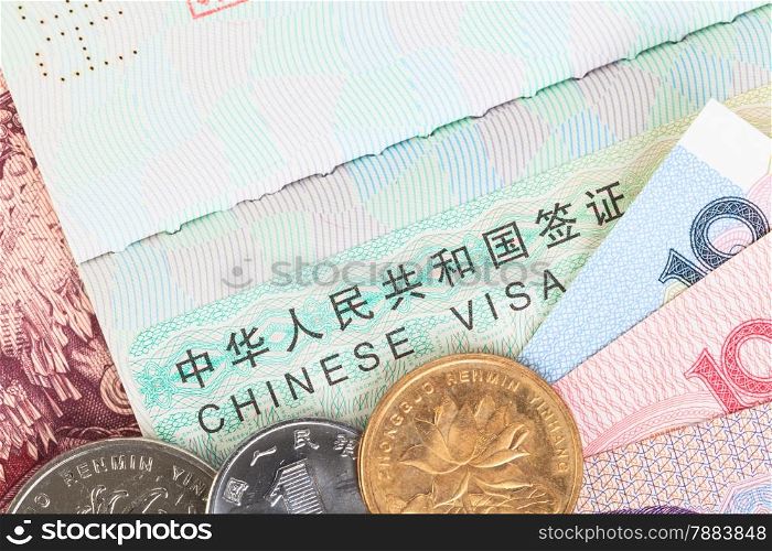 Chinese or Yuan banknotes money and coins from China&rsquo;s currency with visa for travel concept, close up view as background