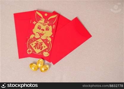 Chinese red envelope with gold bullion, money gift for happy Lunar New Year holiday. Chinese sentence means happiness, healthy, Lucky and Wealthy