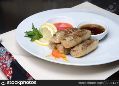 chinese rolls with meat on the plate