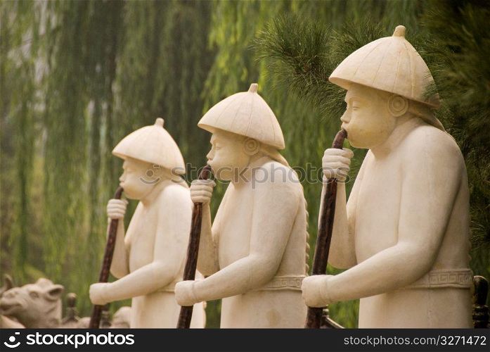 Chinese sculptures of men blowing horns