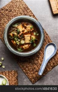 Chinese Sichuan soup with tofu and meat served in bowl , top view. Asian cuisine