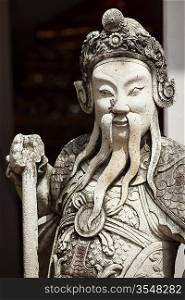 Chinese stone guardian statue close up in Wat Pho Buddhist Temple , Bangkok, Thailand