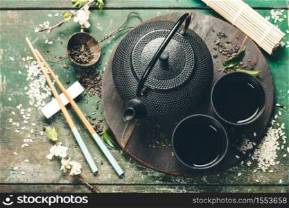 Chinese Tea Set and chopsticks on rustic wooden table, flat lay. Chinese Tea Set and chopsticks on rustic wooden table