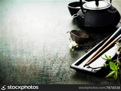 Chinese Tea Set,chopsticks and sakura branch on rustic wooden table