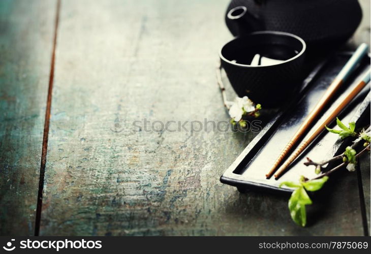 Chinese Tea Set,chopsticks and sakura branch on rustic wooden table