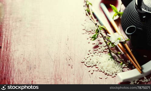 Chinese Tea Set,chopsticks and sakura branch on rustic wooden table