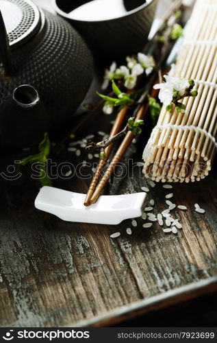 Chinese Tea Set,chopsticks and sakura branch on rustic wooden table