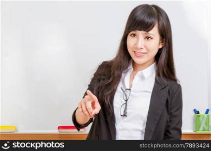 Chinese teacher in front of whiteboard dressed formal