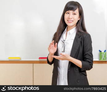 Chinese teacher in front of whiteboard dressed formal