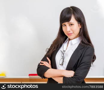 Chinese teacher in front of whiteboard dressed formal