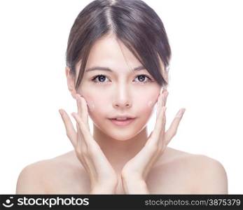 Chinese woman applying cream to face. skincare concept