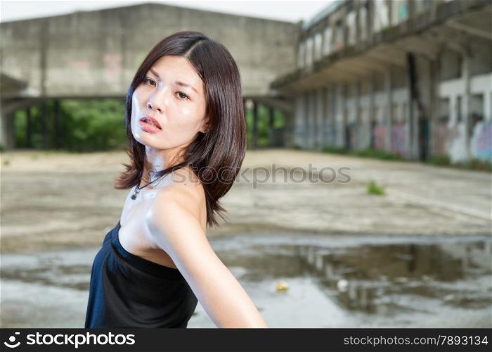 Chinese woman in an old abandoned building