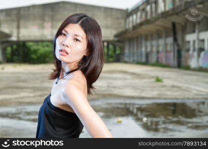 Chinese woman in an old abandoned building