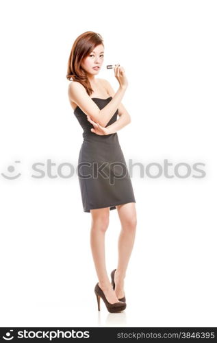 Chinese woman in black dress holding lipstick