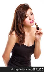 Chinese woman in black dress putting on lipstick