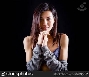 Chinese woman in lingerie and sweater on black background