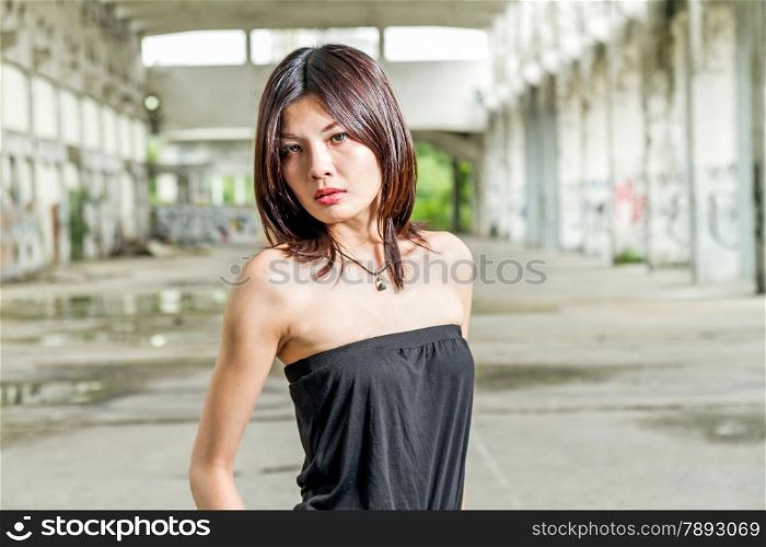 Chinese woman in remains of abandoned building