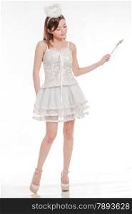 Chinese woman in white angel fairy costume waving her wand