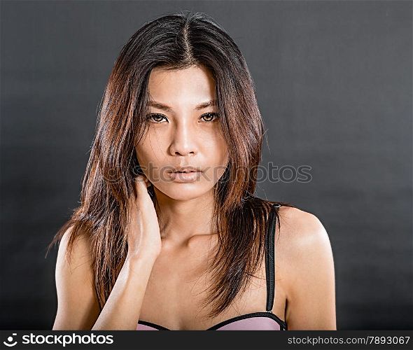 Chinese woman wearing pink and black underwear on black background