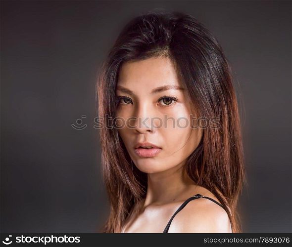 Chinese woman wearing pink and black underwear on black background