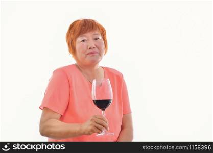Chinese woman with a glass of red wine in her hand, on a light background.