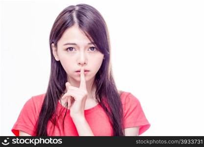 Chinese woman with finger on lips gesturing hush