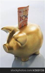 Chinese Yuan note in a piggy bank