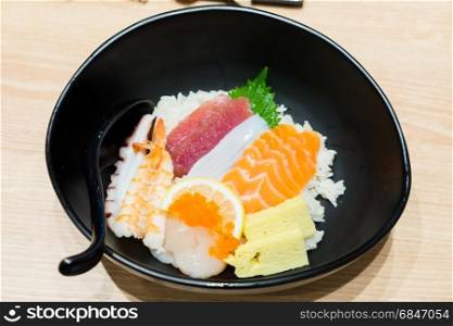 Chirashi Sushi bowl with salmon tuna shrimp served with Wasabi. Chirashi Sushi bowl with salmon, tuna, shrimp, scallops, sea bass, sweet omelette served with Wasabi