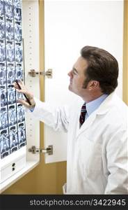 Chiropractic doctor examining a CT scan of the spine.