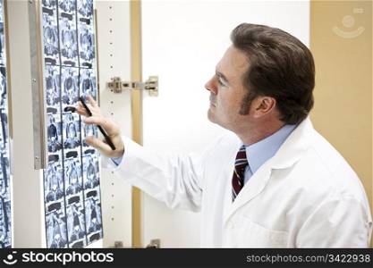 Chiropractic doctor examining the results of a CAT scan of the spine.