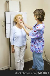 Chiropractic patient is positioned for an x-ray by a radiology technician.