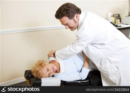 Chiropractor adjusting a female patient&rsquo;s spine. Plenty of room for text.