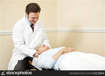 Chiropractor adjusting the neck of an elderly female patient.