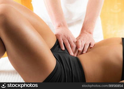 Chiropractor Doing Treatment with Female Athlete. Osteopath working with patient