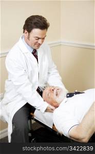 Chiropractor treats a senior man for neck pain.
